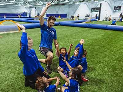 Youth players cheering after playing soccer, football, baseball.